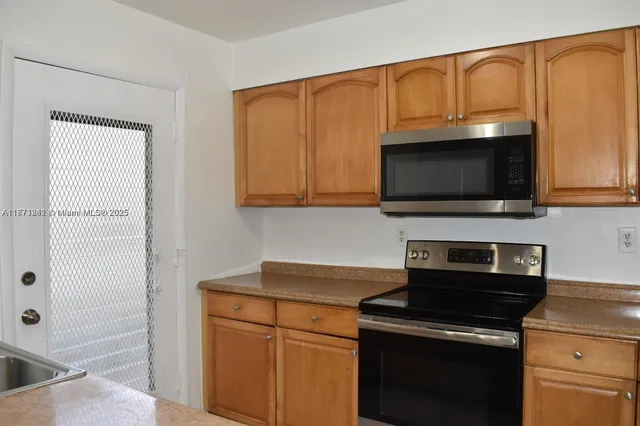 a kitchen with a stove and a microwave