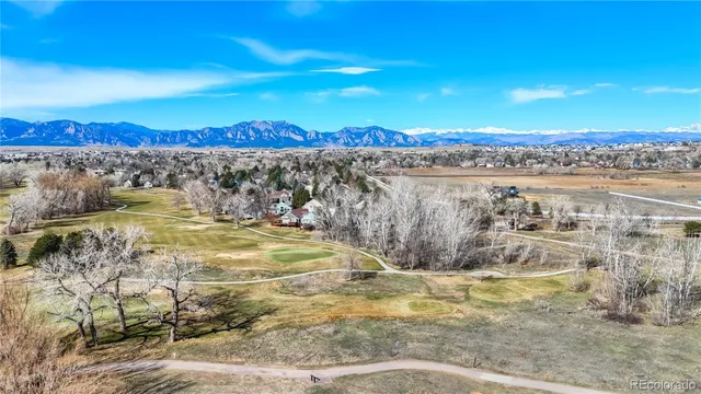 a view of a swimming pool with an outdoor seating and a garden