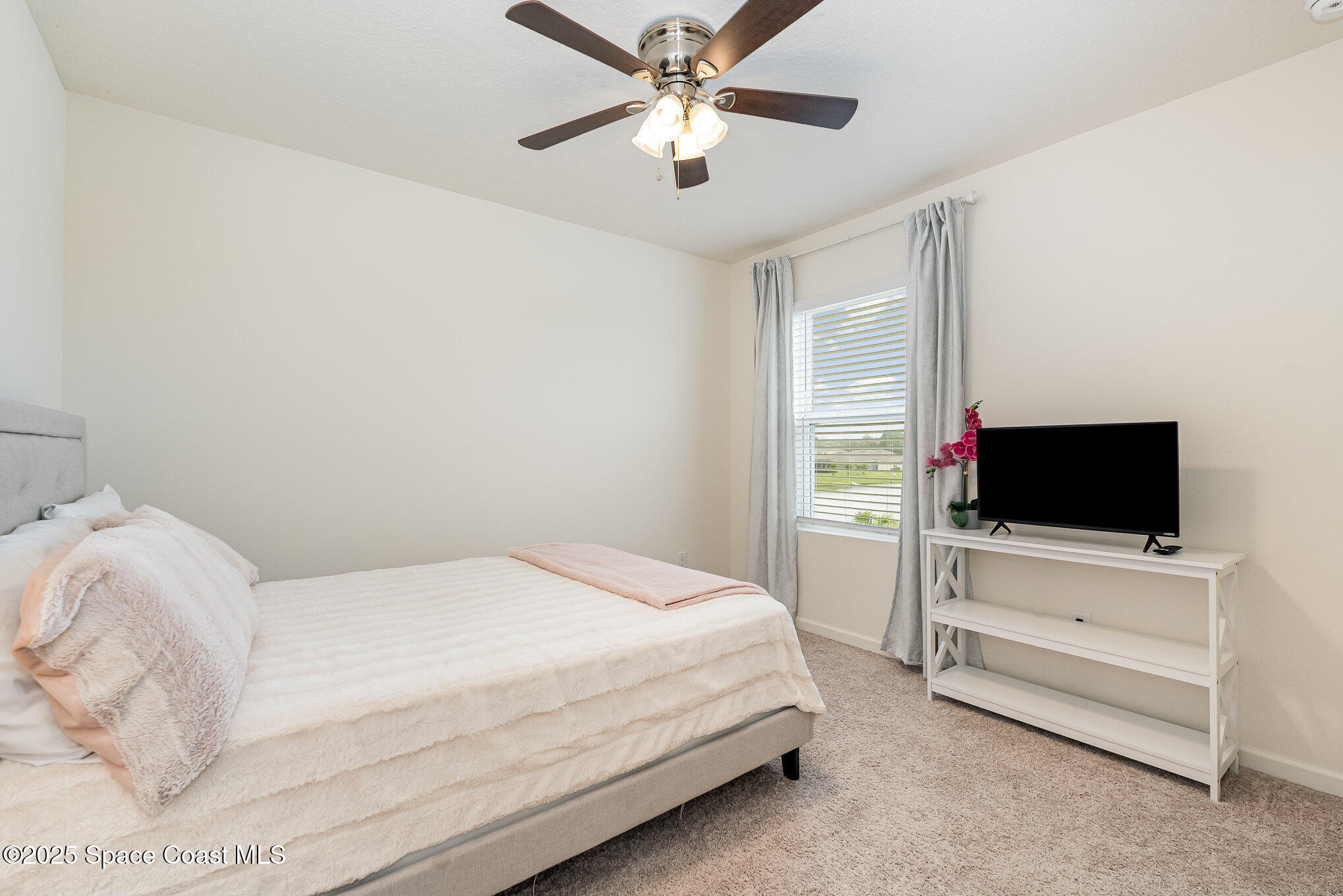735 Sorrento Drive Cocoa, FL 32922 - Photo 12 of 23 a bedroom with a bed and a flat screen tv