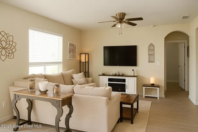 a living room with fireplace furniture and a flat screen tv