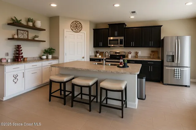 a kitchen with granite countertop a table chairs microwave and cabinets