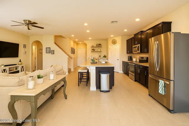 a kitchen with stainless steel appliances granite countertop a sink a stove and a refrigerator