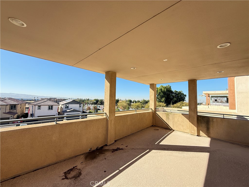 101 Interval Irvine, CA 92618 - Photo 15 of 20 a view of a kitchen with kitchen island a sink wooden floor and counter space