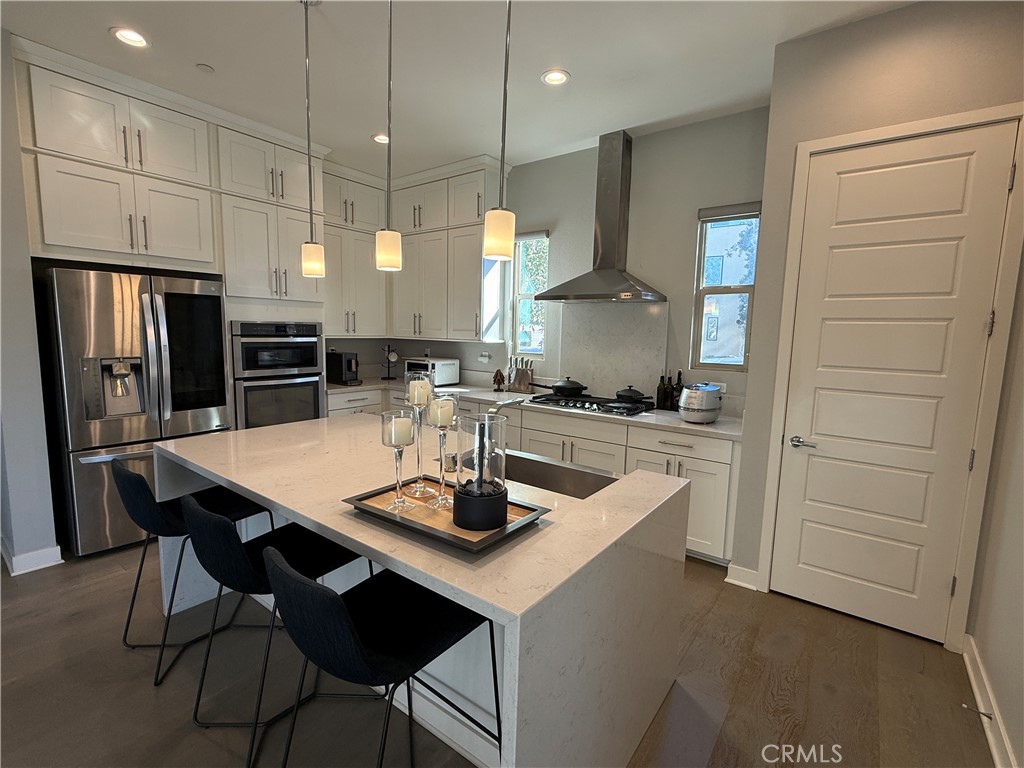 101 Interval Irvine, CA 92618 - Photo 2 of 20 a kitchen with refrigerator and cabinets