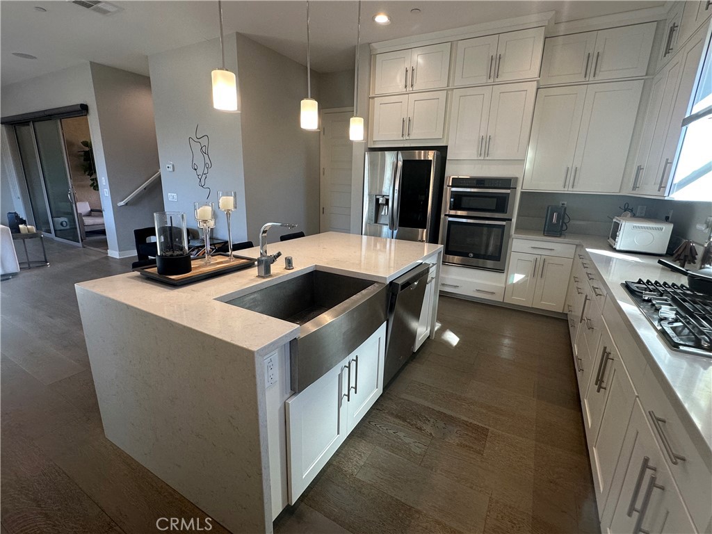 101 Interval Irvine, CA 92618 - Photo 3 of 20 a kitchen with kitchen island stainless steel appliances a sink stove and refrigerator