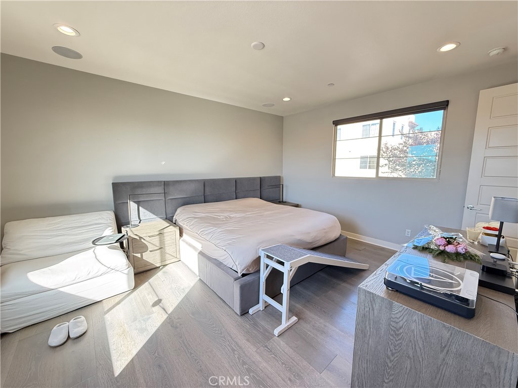 101 Interval Irvine, CA 92618 - Photo 6 of 20 a bedroom with a bed and wooden floor