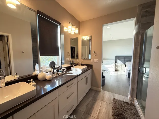 a bathroom with a double vanity sink and mirror
