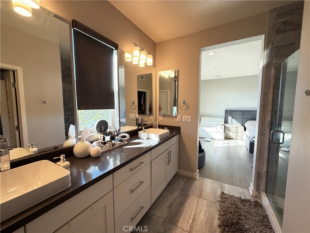 101 Interval Irvine, CA 92618 - Photo 8 of 20 a bathroom with a double vanity sink and mirror