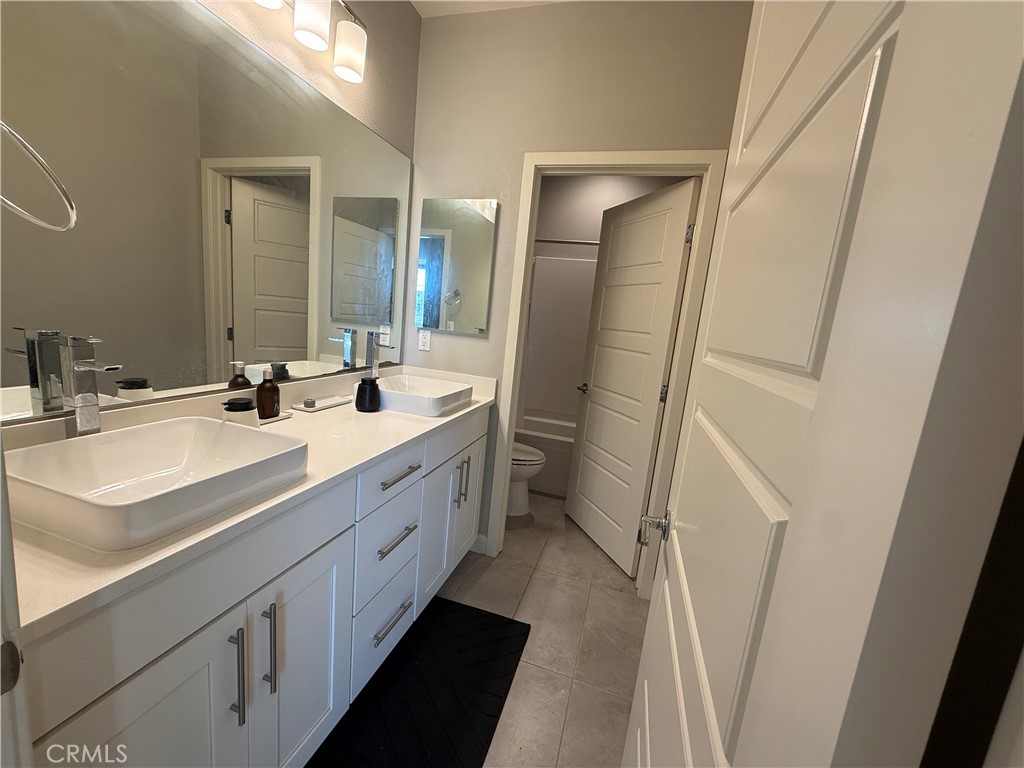 101 Interval Irvine, CA 92618 - Photo 10 of 20 a bathroom with a double vanity sink and mirror