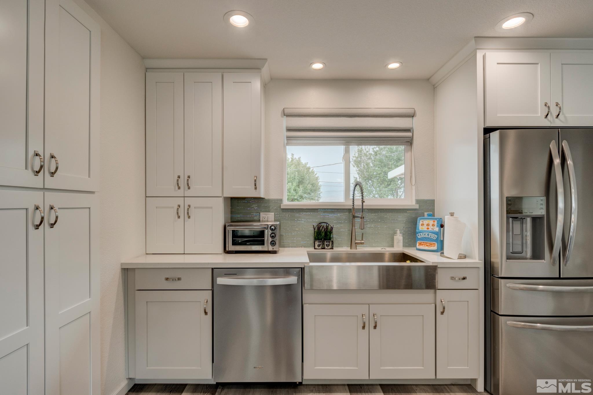 3360 Canvasback Lane Reno, NV 89508 - Photo 20 of 35 a kitchen with white cabinets and refrigerator