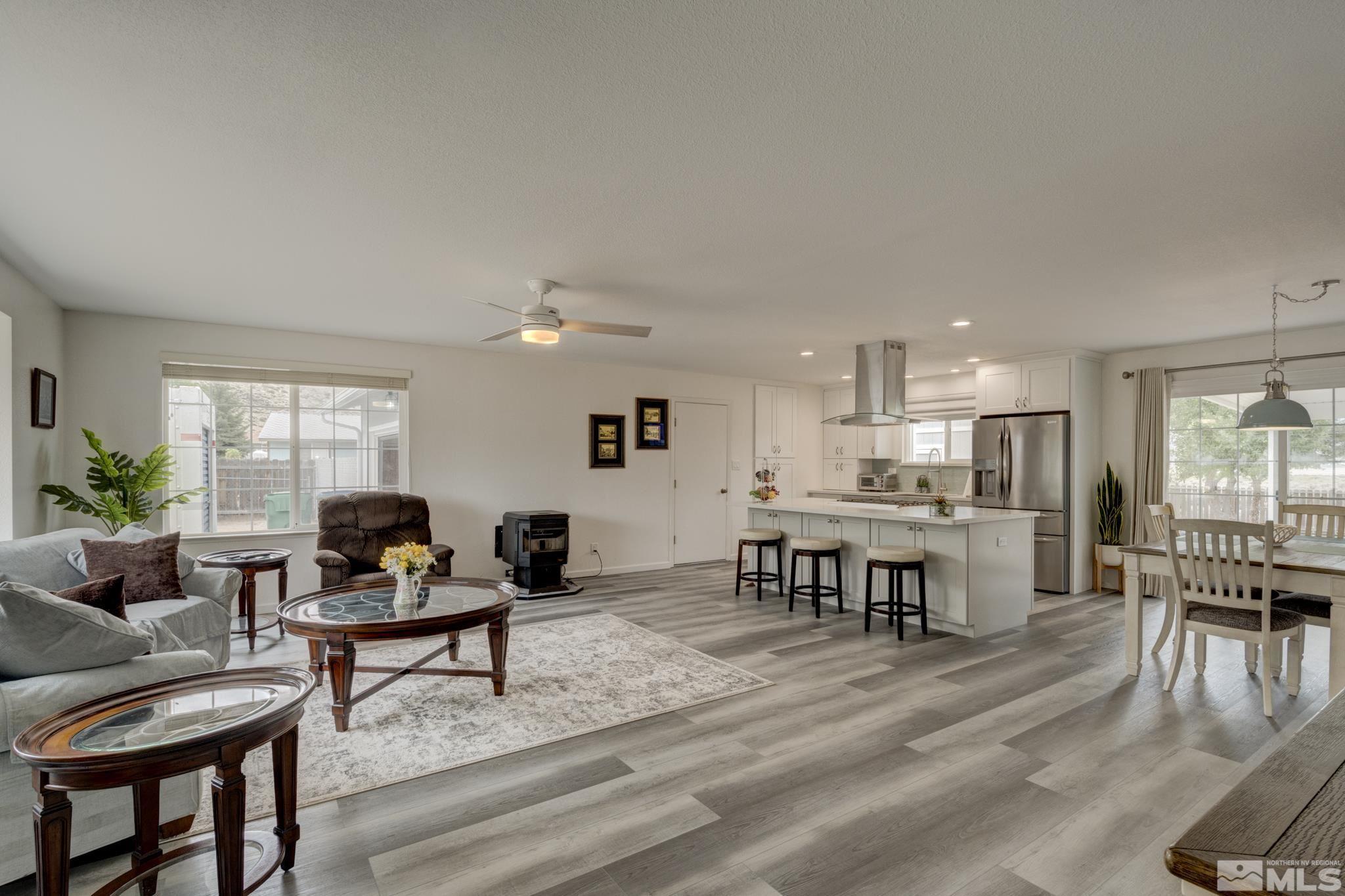 3360 Canvasback Lane Reno, NV 89508 - Photo 3 of 35 a living room with furniture and a dining table with kitchen view