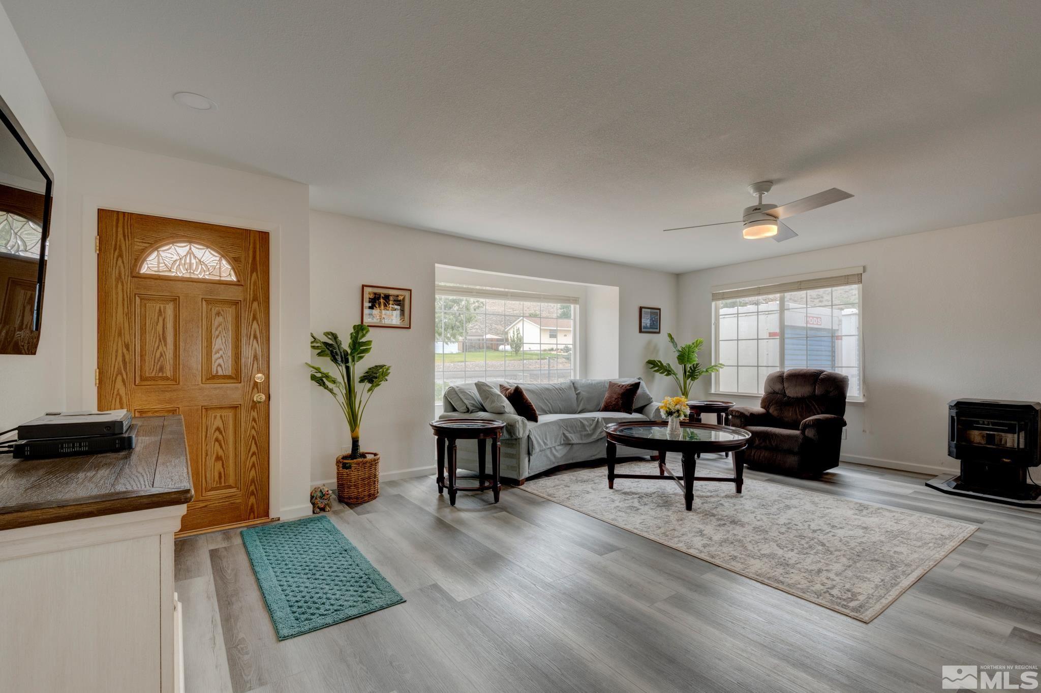 3360 Canvasback Lane Reno, NV 89508 - Photo 6 of 35 a living room with furniture and a flat screen tv with wooden floor