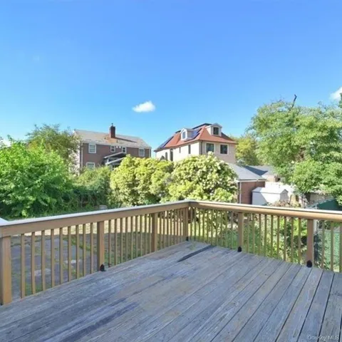 a view of a balcony with wooden fence