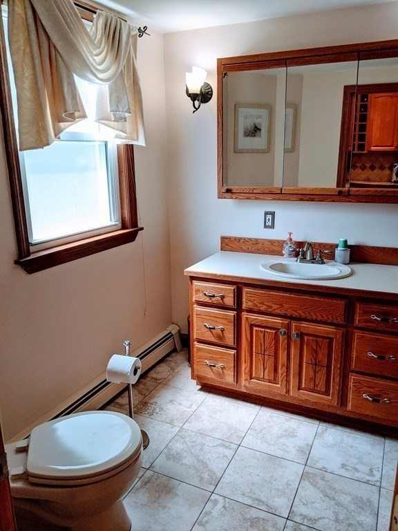 9 Byron Street Wakefield, MA 01880 - Photo 11 of 42 a bathroom with a toilet a sink and mirror