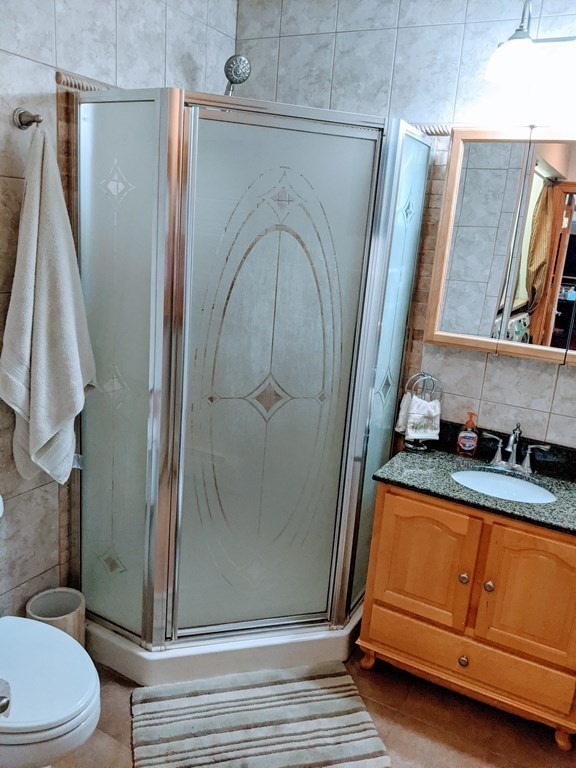 9 Byron Street Wakefield, MA 01880 - Photo 15 of 42 a bathroom with a granite countertop sink and a mirror