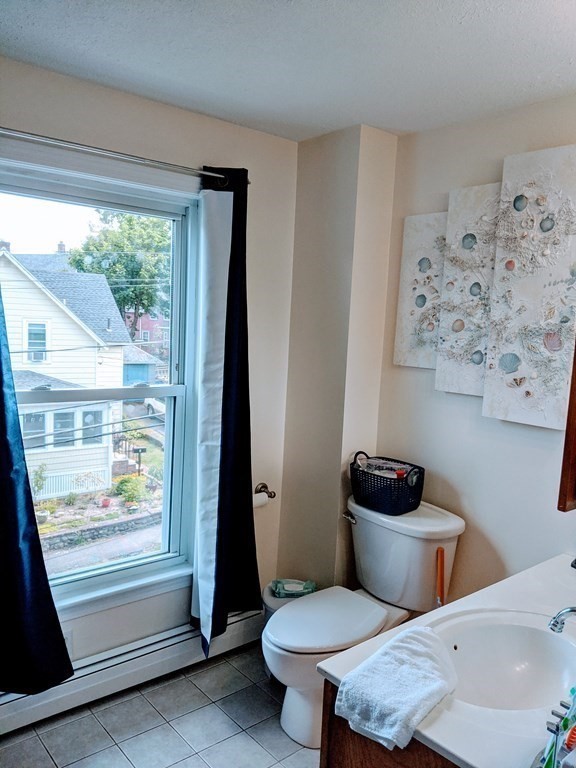 9 Byron Street Wakefield, MA 01880 - Photo 20 of 42 a bathroom with a toilet a sink and a window