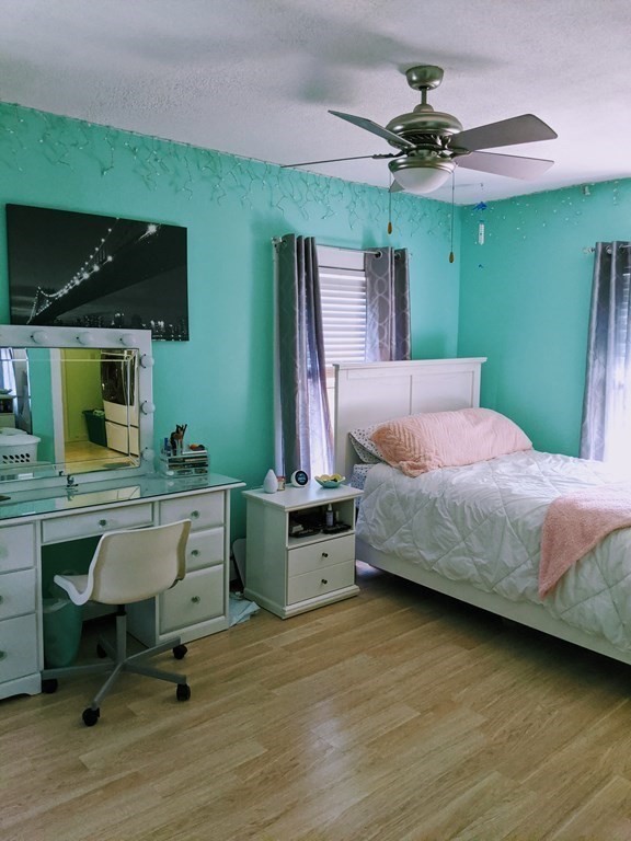 9 Byron Street Wakefield, MA 01880 - Photo 28 of 42 a bedroom with a bed and a chandelier