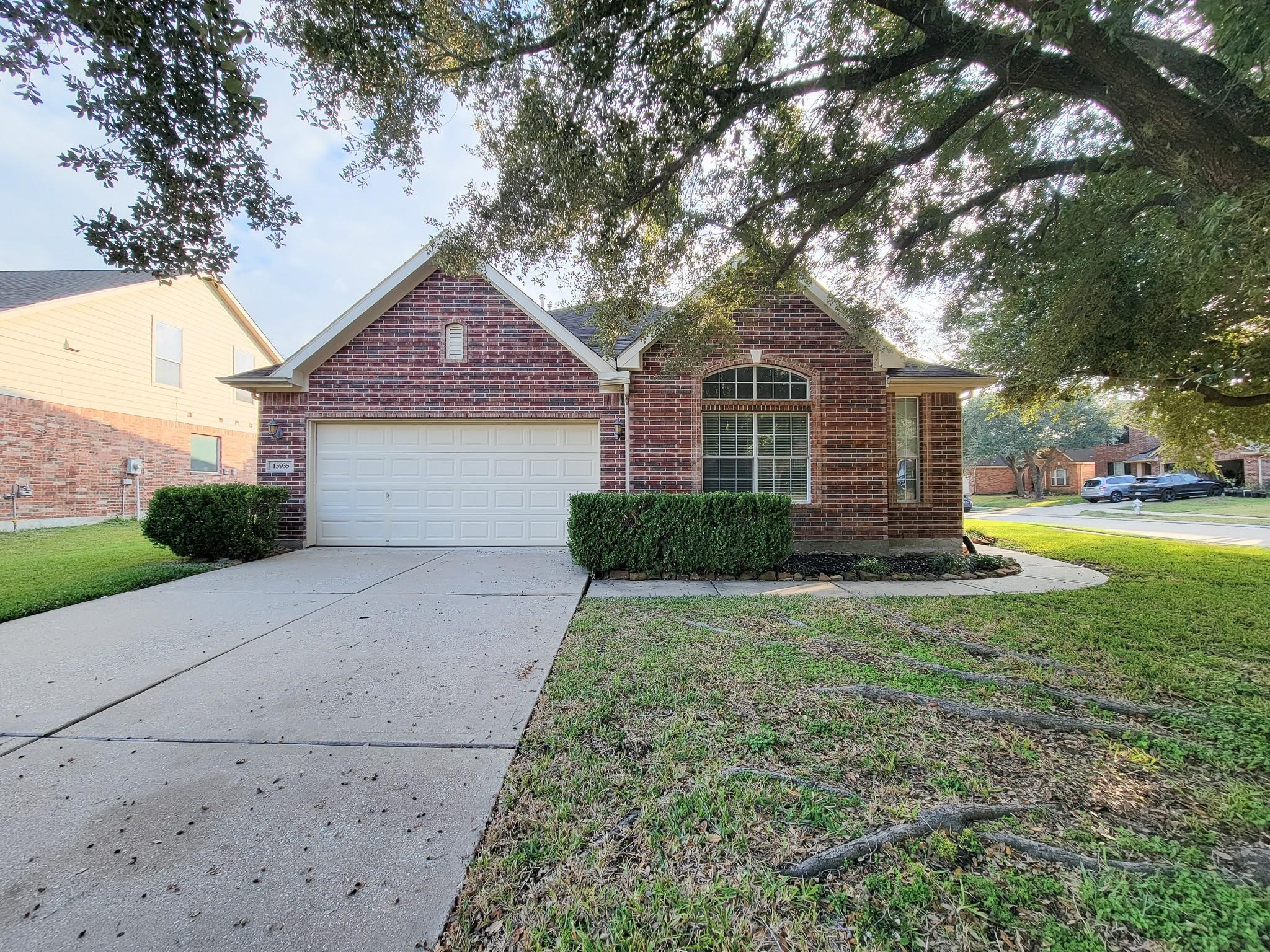 13935 Charterhouse Way Sugar Land, TX 77498 - Photo 1 of 36 a front view of a house with a yard and trees