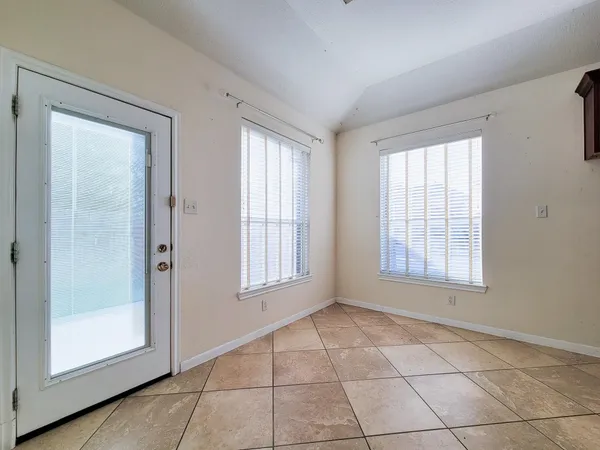 an empty room with windows and closet