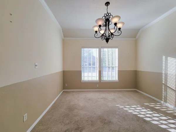 a view of a room with a window and a chandelier
