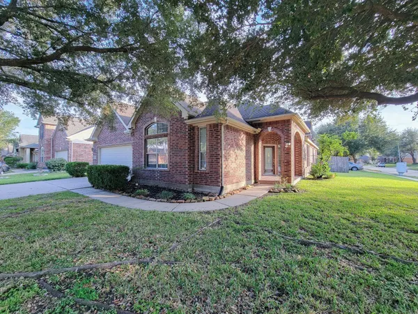 a front view of a house with yard and green space