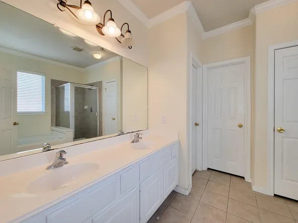 a bathroom with a double vanity sink and a mirror