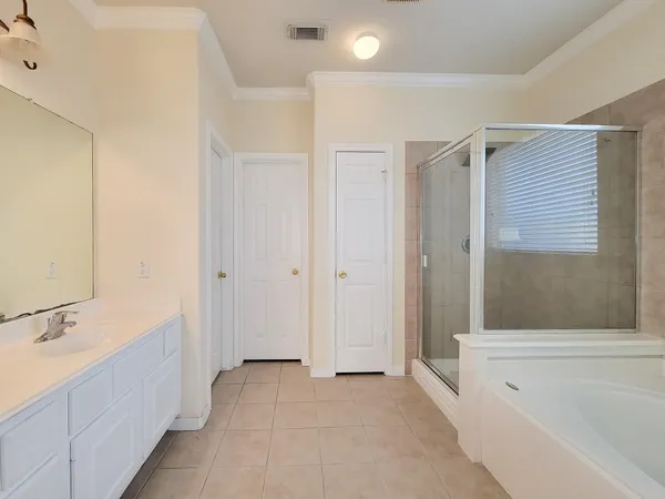 a bathroom with a tub sink and mirror