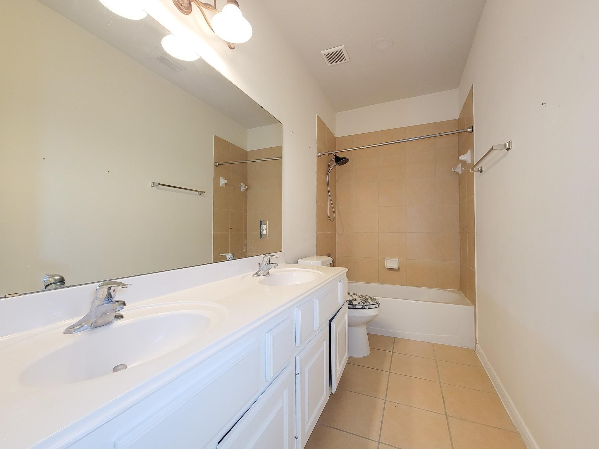 13935 Charterhouse Way Sugar Land, TX 77498 - Photo 30 of 36 a bathroom with a double vanity sink mirror double and a bathtub