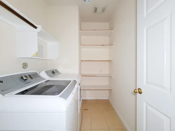 a view of storage and utility room with washer and dryer