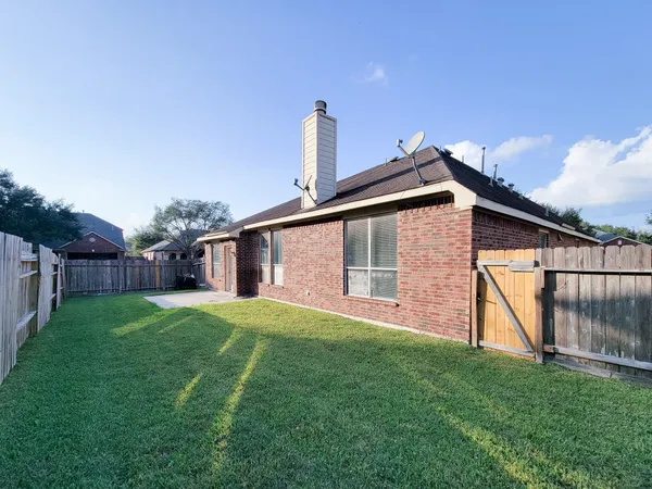 a backyard of a house with wooden fence