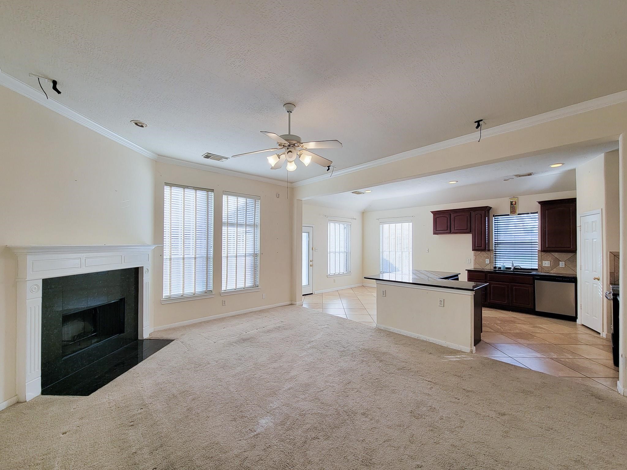 13935 Charterhouse Way Sugar Land, TX 77498 - Photo 7 of 36 a large kitchen with a stove and a fireplace