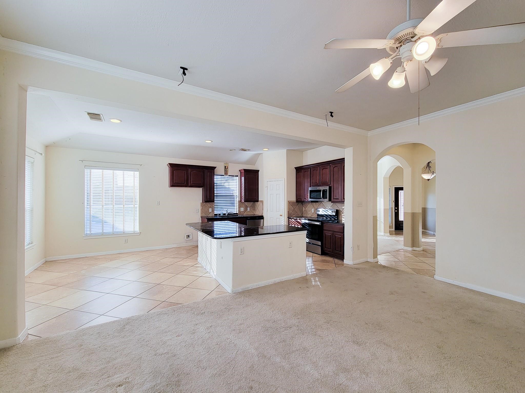 13935 Charterhouse Way Sugar Land, TX 77498 - Photo 8 of 36 a view of a living room a kitchen and a chandelier fan