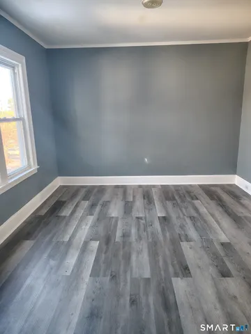 a view of a room with wooden floor