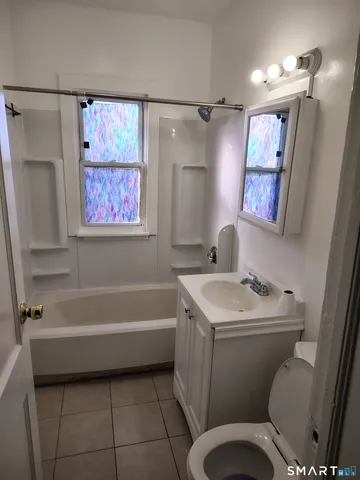 a bathroom with a sink toilet and a bathtub