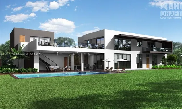 a front view of building with yard and outdoor seating