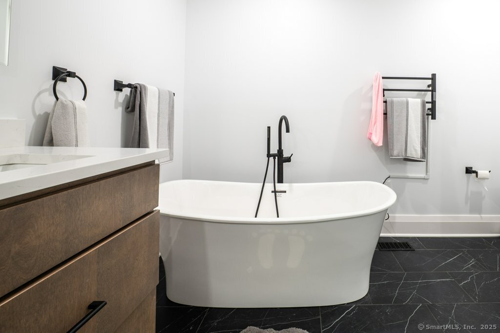 78 Blue Hills Road North Haven, CT 06473 - Photo 23 of 40 a white bath tub sitting in a bathroom