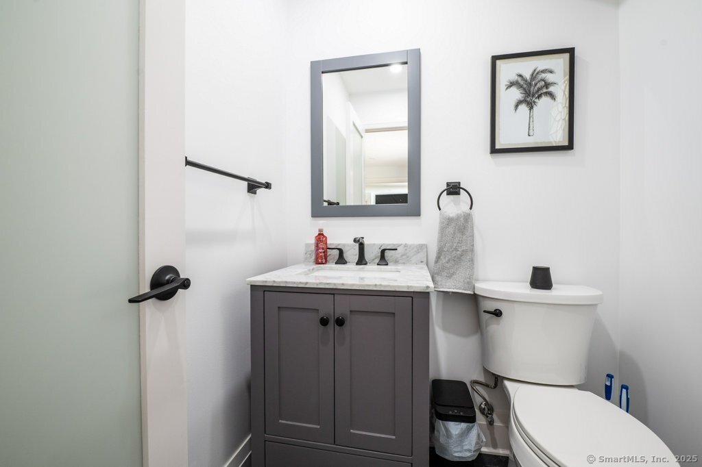 78 Blue Hills Road North Haven, CT 06473 - Photo 30 of 40 a bathroom with a sink mirror and toilet