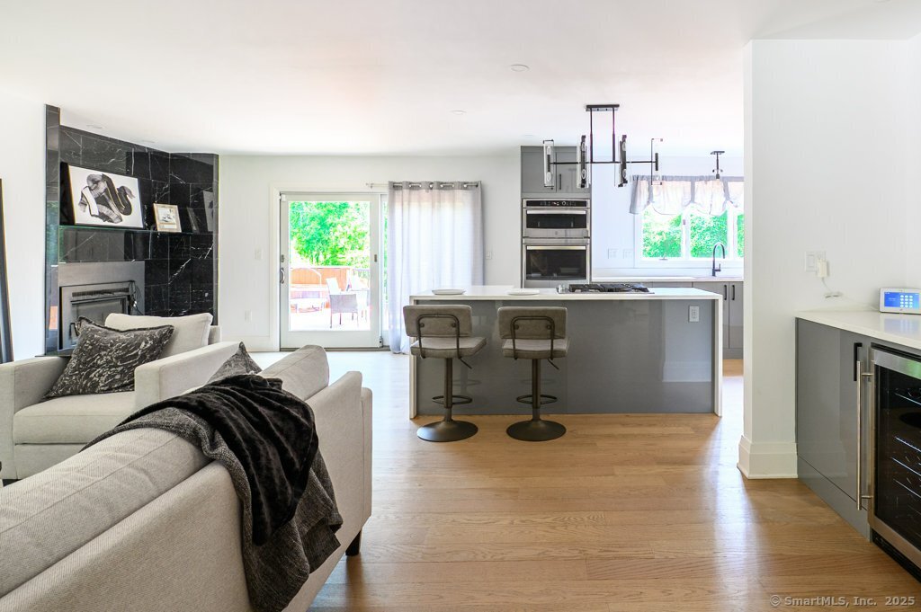 78 Blue Hills Road North Haven, CT 06473 - Photo 32 of 40 a living room with furniture a fireplace and a table