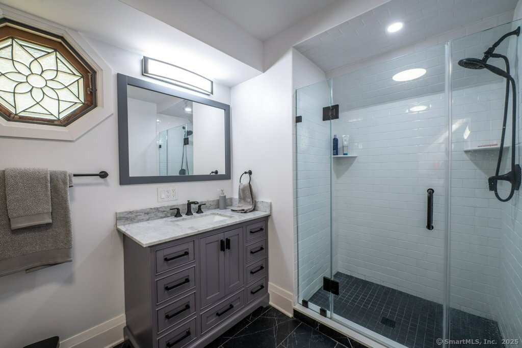 78 Blue Hills Road North Haven, CT 06473 - Photo 40 of 40 a bathroom with a double vanity sink mirror and shower
