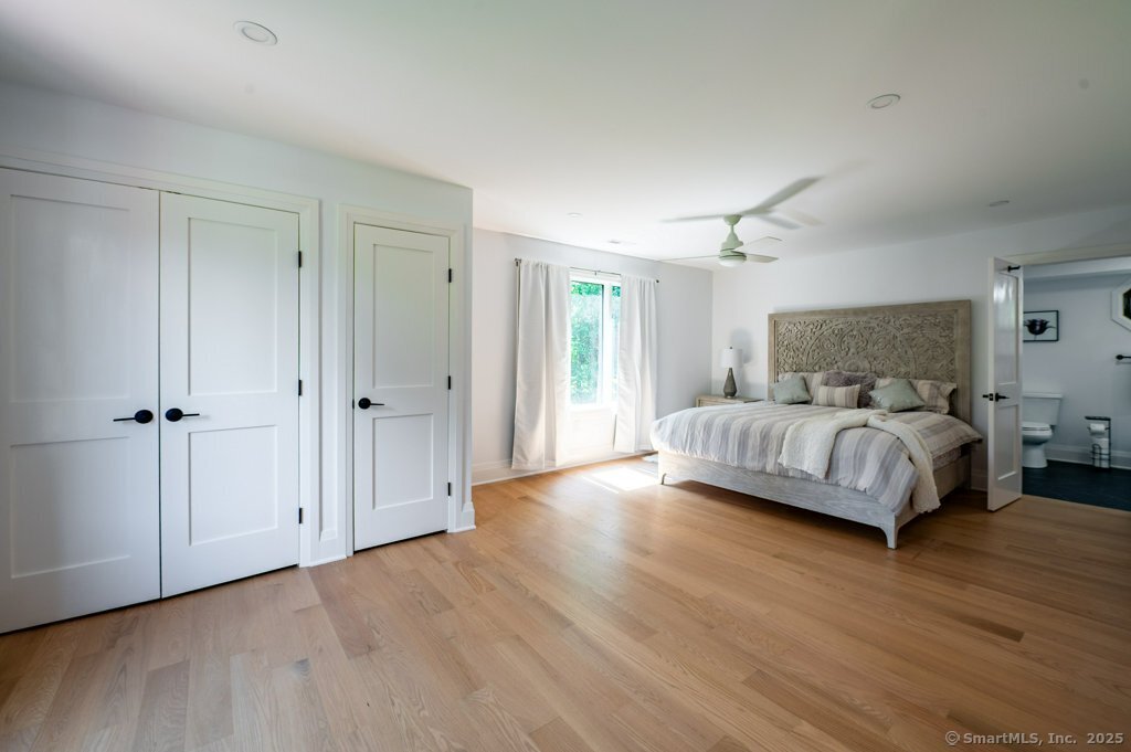 78 Blue Hills Road North Haven, CT 06473 - Photo 4 of 40 a bedroom with a bed and wooden floor