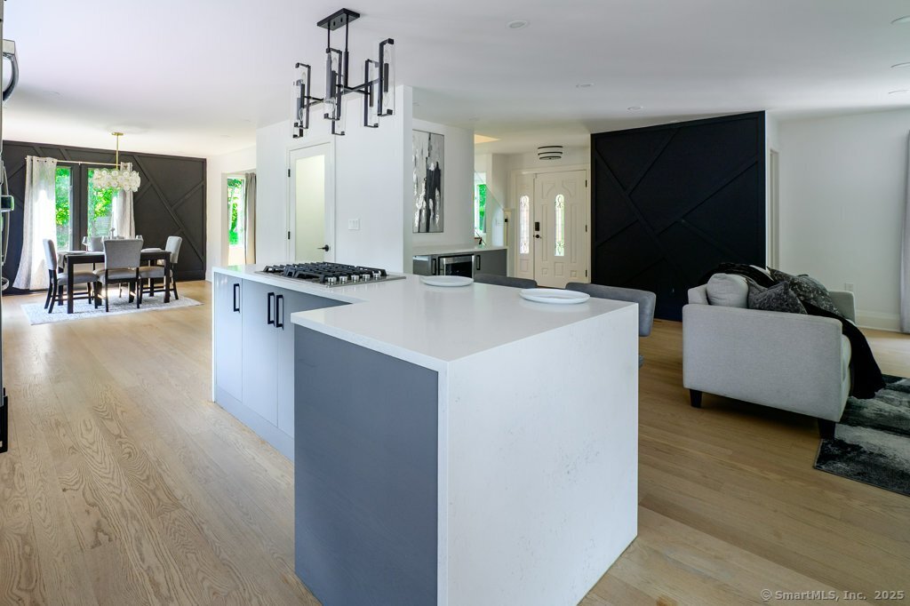 78 Blue Hills Road North Haven, CT 06473 - Photo 8 of 40 a view of kitchen island with stainless steel appliances wooden floor and living room view