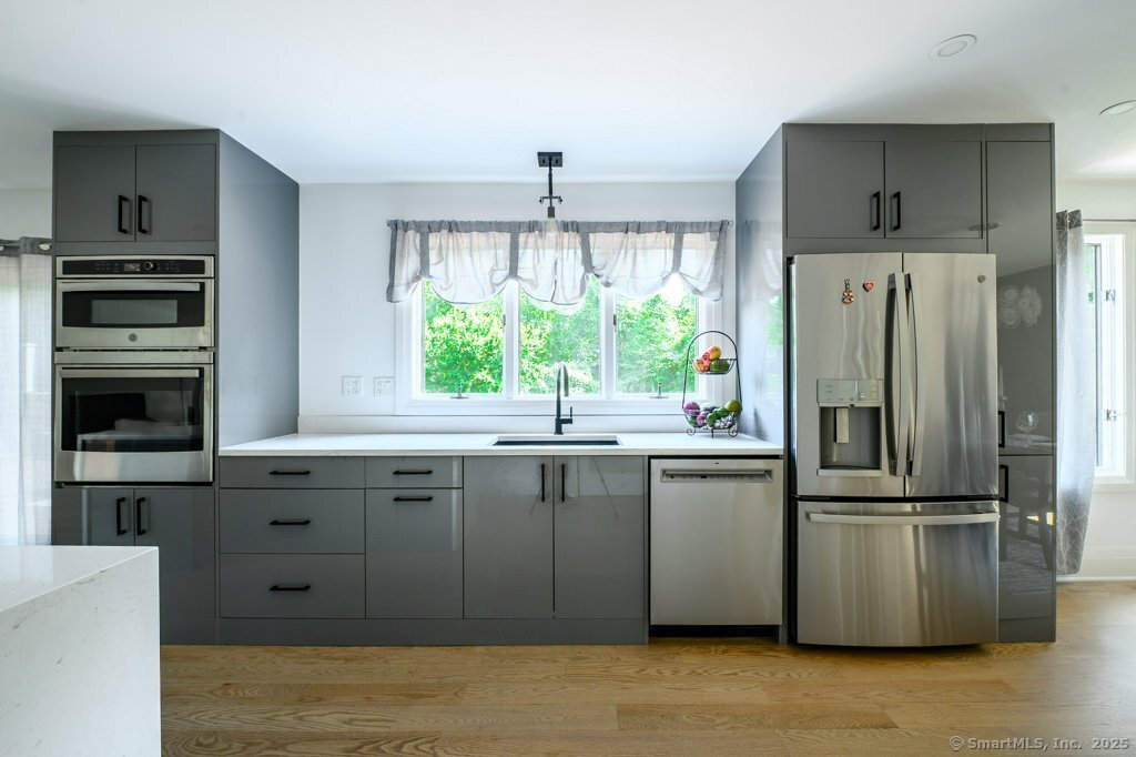 78 Blue Hills Road North Haven, CT 06473 - Photo 9 of 40 a kitchen with a refrigerator and a sink