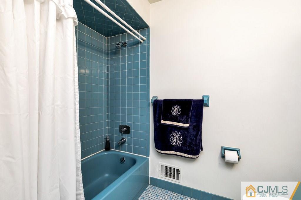 6 Birch Road Edison, NJ 08817 - Photo 14 of 27 a bathroom with a bathtub and a shower