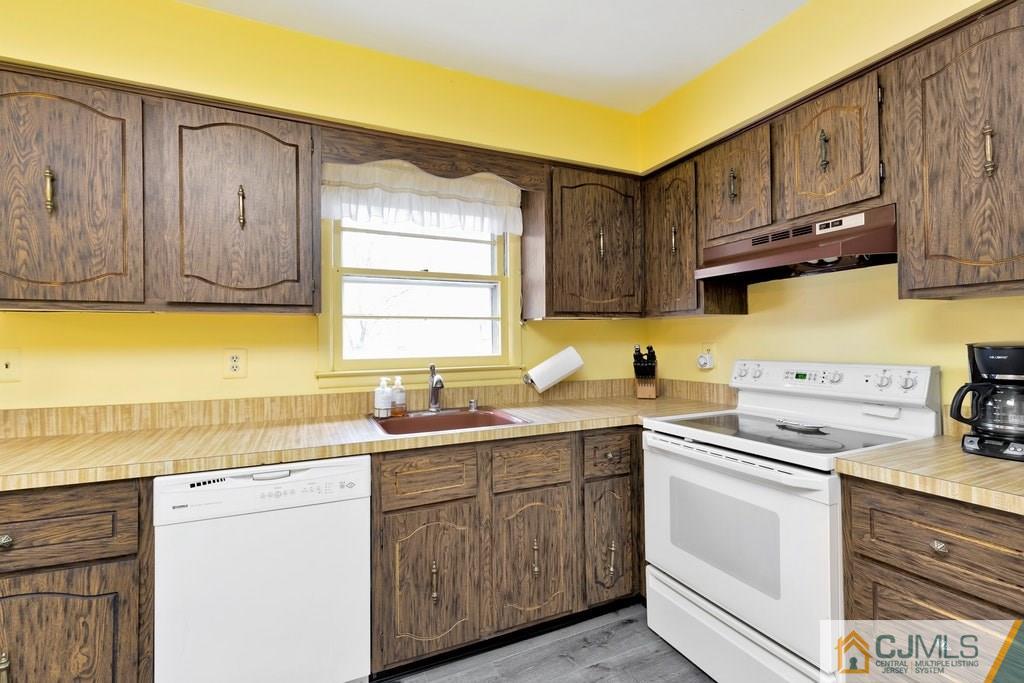 6 Birch Road Edison, NJ 08817 - Photo 8 of 27 a kitchen with stainless steel appliances granite countertop a sink stove and cabinets