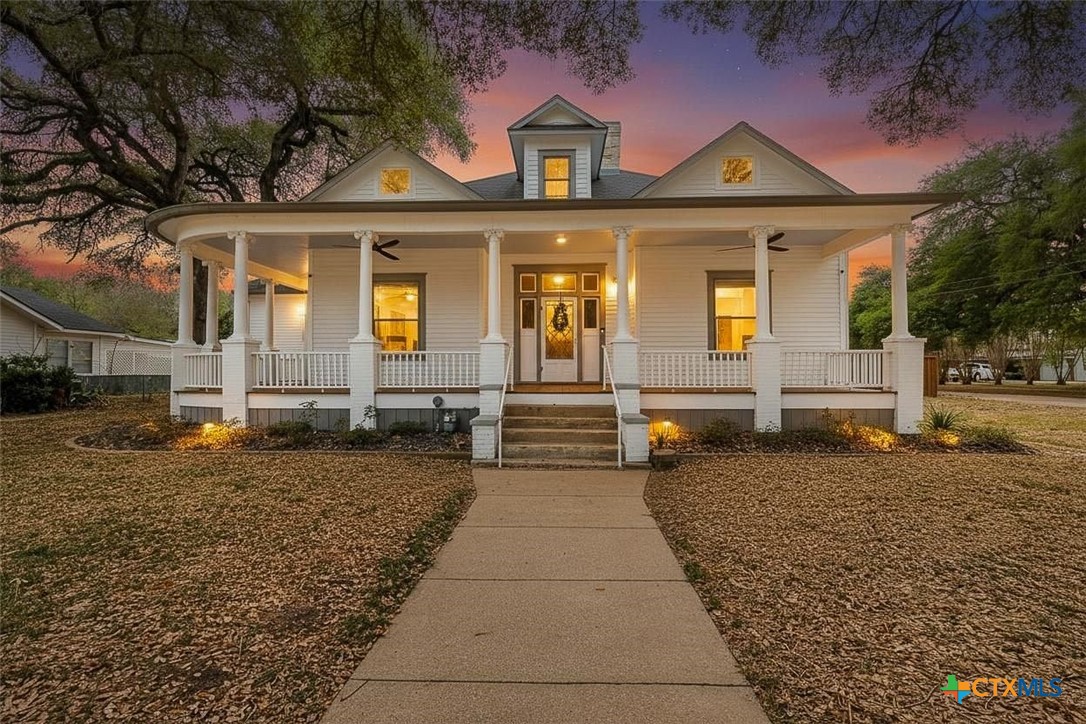 604 St Michael Street Gonzales, TX 78629 - Photo 1 of 37 a front view of a house with a yard