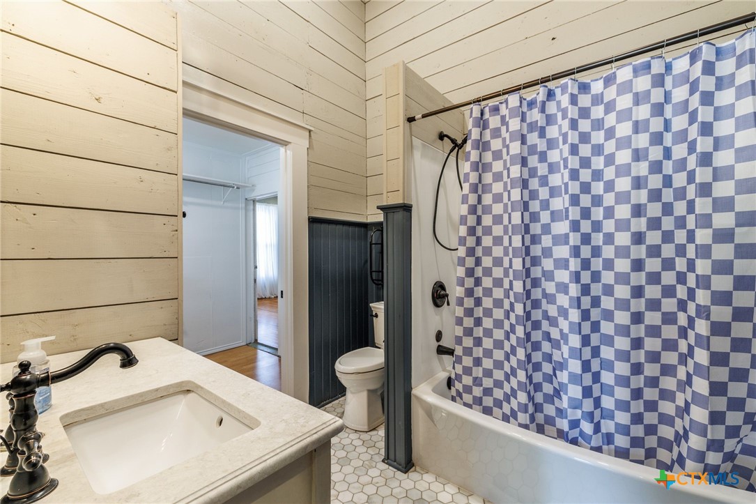 604 St Michael Street Gonzales, TX 78629 - Photo 21 of 37 a bathroom with a sink toilet and shower