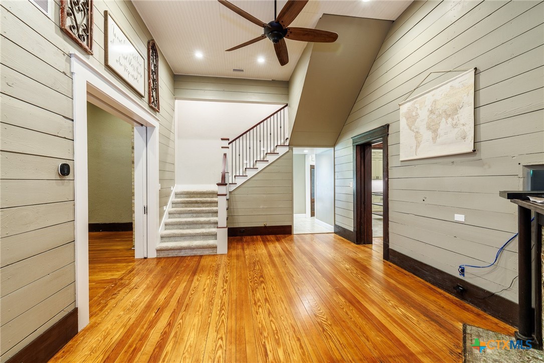 604 St Michael Street Gonzales, TX 78629 - Photo 22 of 37 a view of a hallway with wooden floor and staircase
