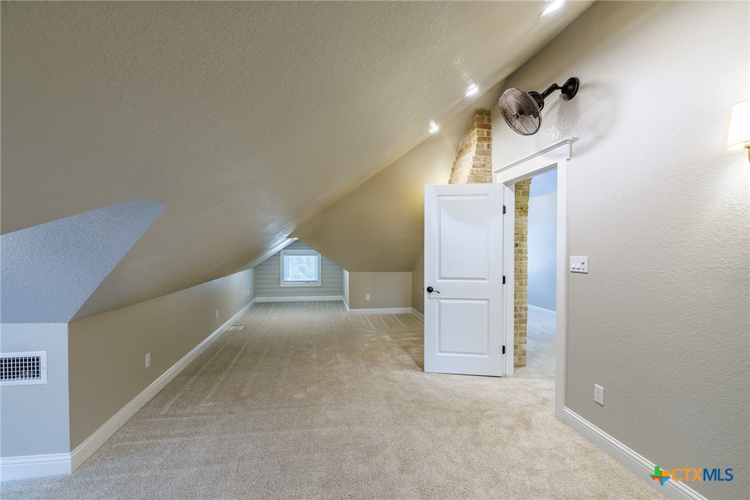 604 St Michael Street Gonzales, TX 78629 - Photo 24 of 37 a view of a hallway with windows and stairs