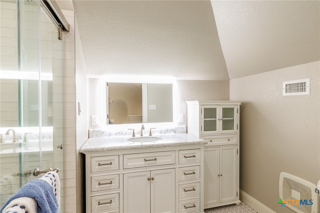 604 St Michael Street Gonzales, TX 78629 - Photo 25 of 37 a bathroom with a granite countertop sink mirror and double