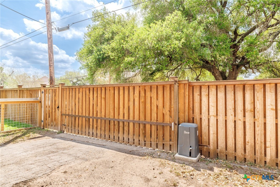 604 St Michael Street Gonzales, TX 78629 - Photo 33 of 37 a view of a backyard with wooden fence